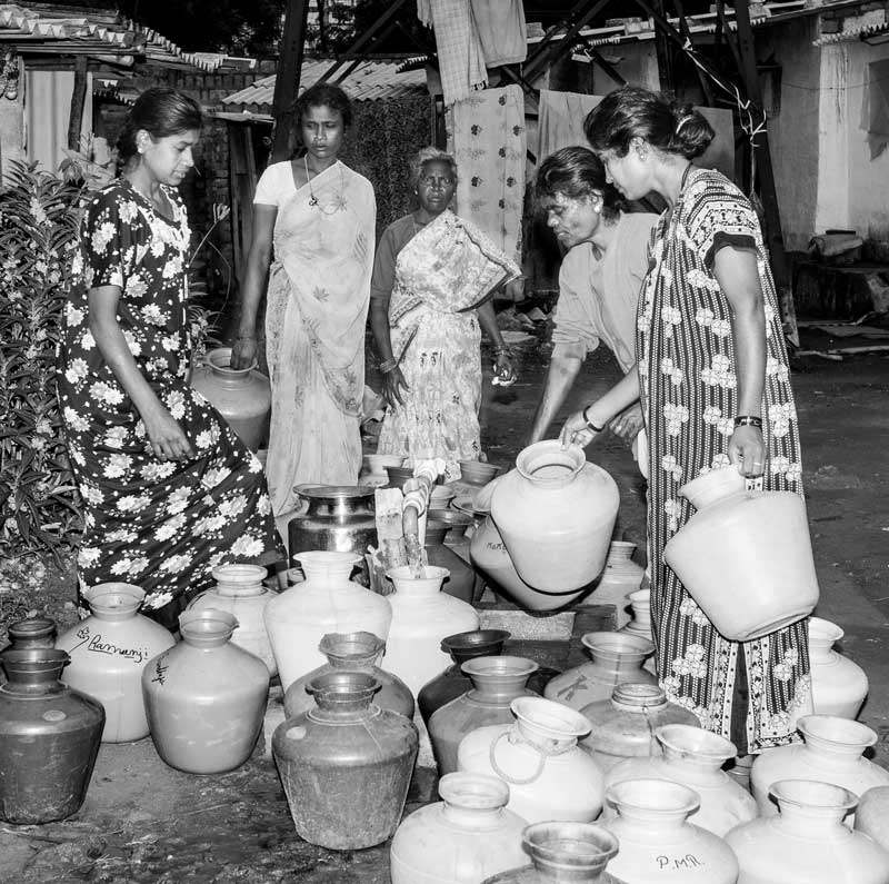 Women and Drinking Water Challenges - Waiting in a queue to fetch drinking water at a public standpoint early at dawn in Bengaluru, Karnataka